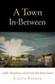 Book cover of: Town in-Between. By: Judith E. Ridner